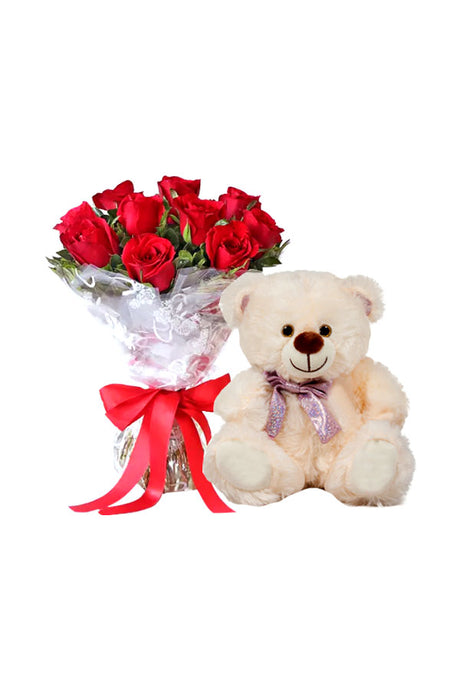 Fresh red roses arranged with a soft plush teddy bear